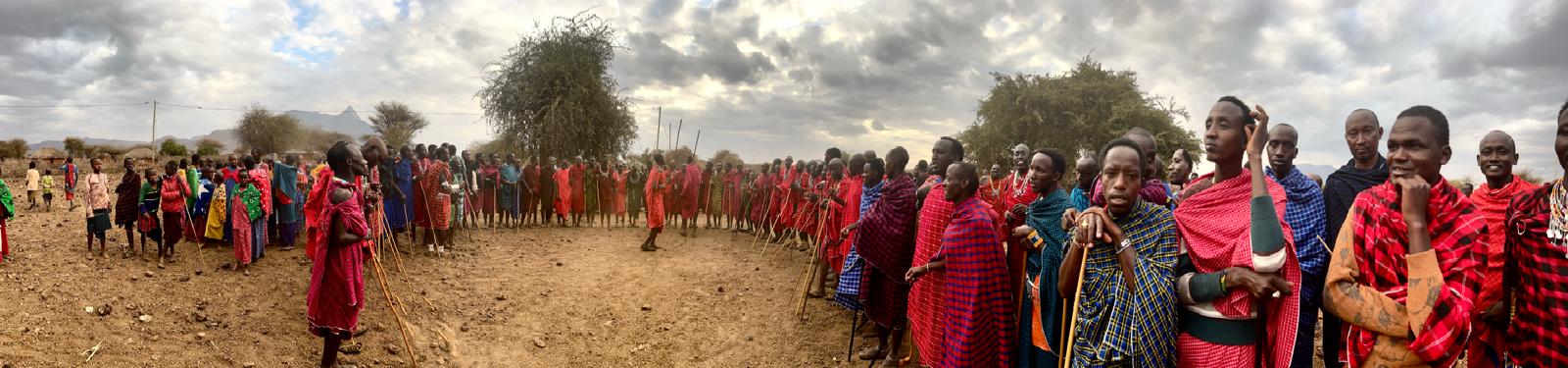 Maasai community members gathering outdoors in Kimokouwa