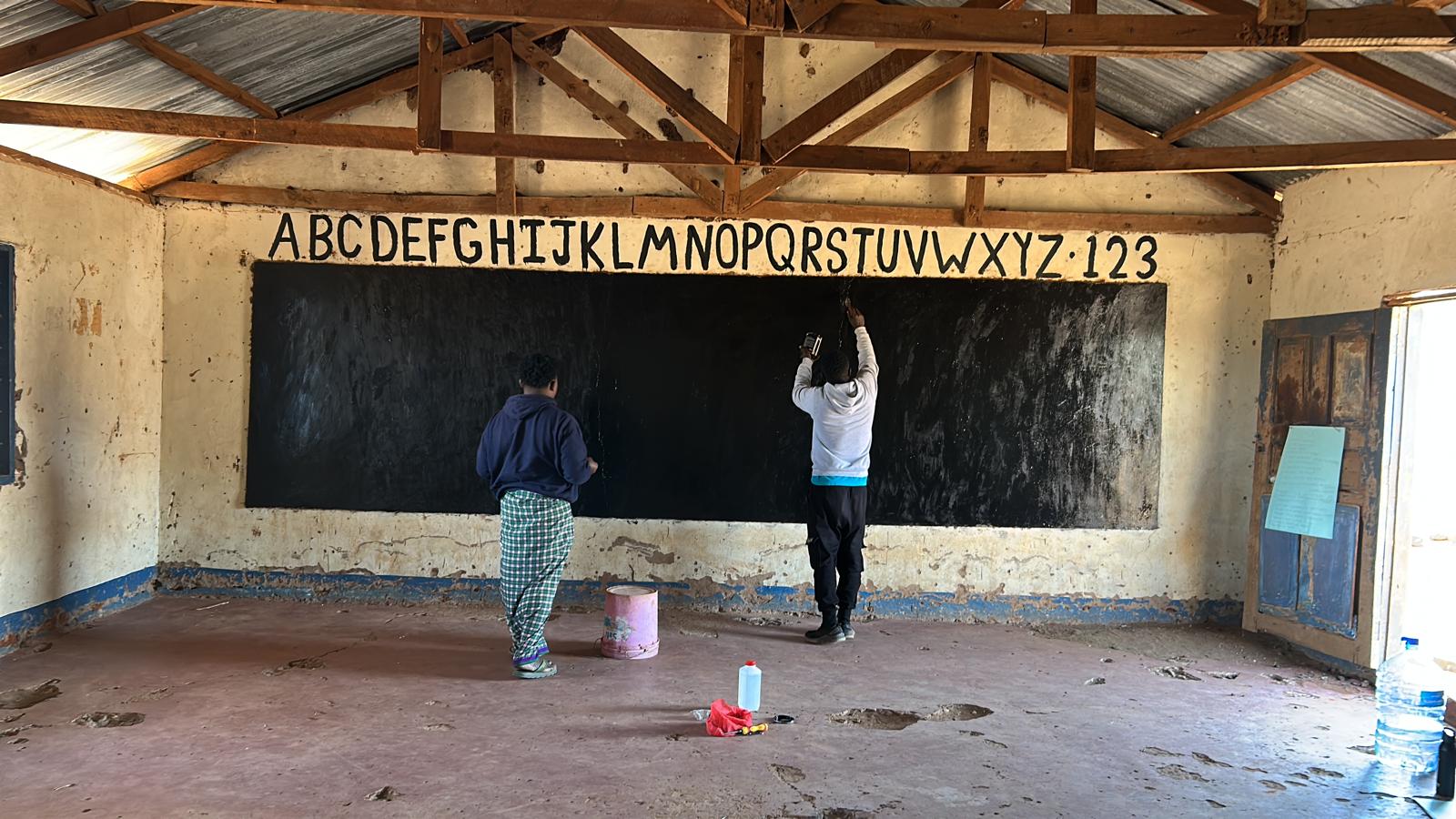 Teacher guiding students in a bright classroom